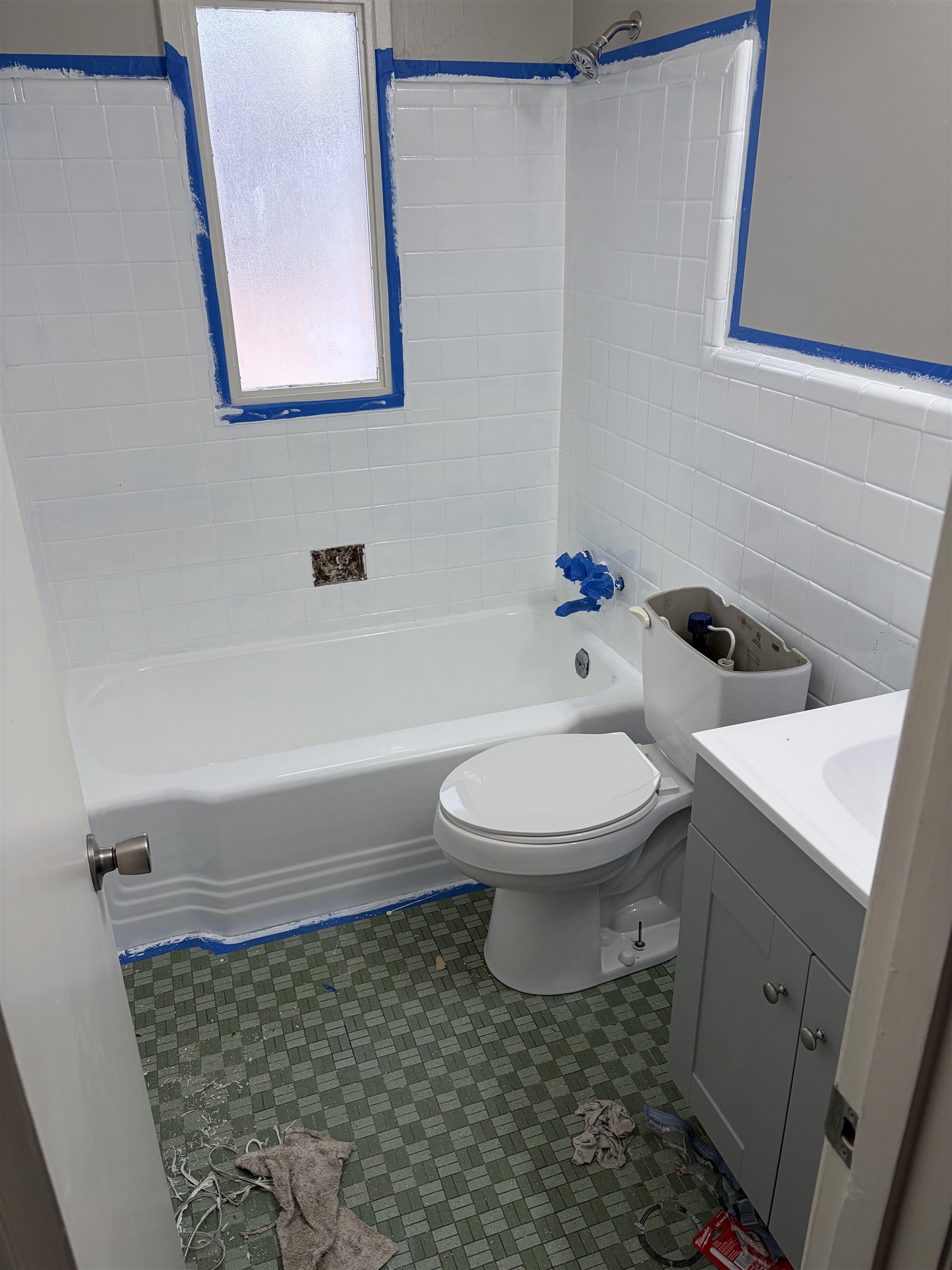 4928 Willow Road Memphis, TN 38117 - Photo 7 of 16 Bathroom with tile walls, vanity, shower combination, and dark tile patterned flooring