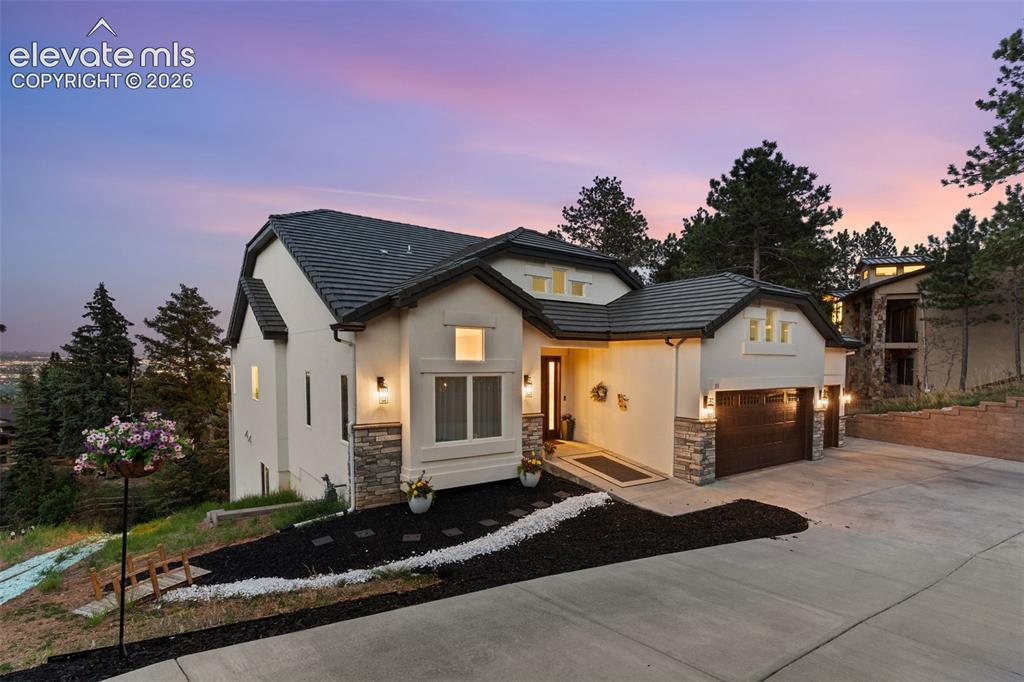 21 Leaming Road Colorado Springs, CO 80906 - Photo 4 of 48 Contemporary stucco exterior with dark tile roofing and stone accents