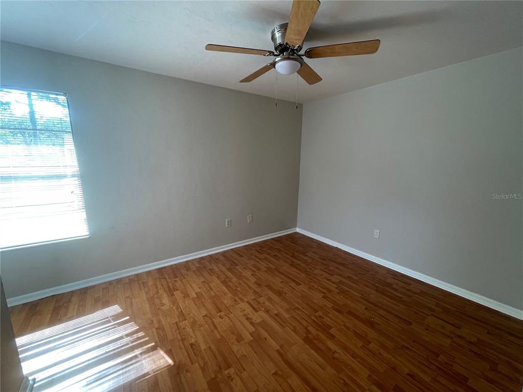 4345 Southwest 20th Lane, Unit 4345 Gainesville, FL 32607 - Photo 15 of 36 a view of empty room with wooden floor and fan