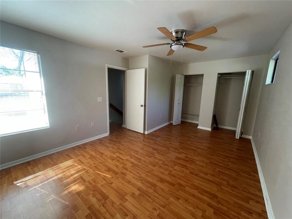 4345 Southwest 20th Lane, Unit 4345 Gainesville, FL 32607 - Photo 17 of 36 wooden floor in an empty room with a window