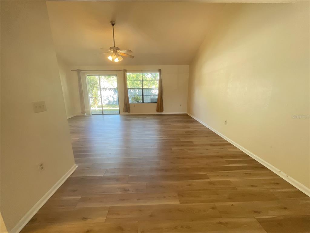 4345 Southwest 20th Lane, Unit 4345 Gainesville, FL 32607 - Photo 18 of 36 an empty room with wooden floor and windows