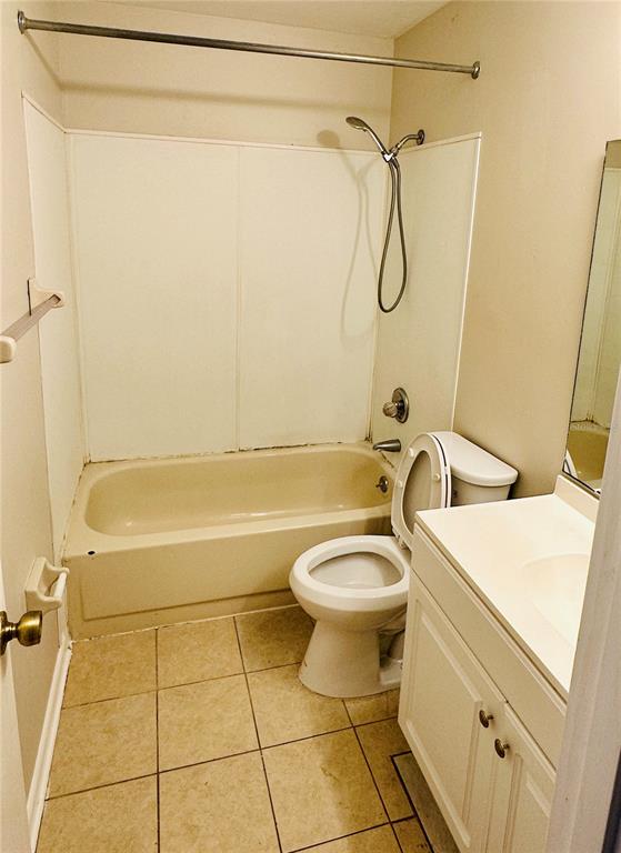 4345 Southwest 20th Lane, Unit 4345 Gainesville, FL 32607 - Photo 25 of 36 a bathroom with a granite countertop bathtub shower sink vanity and toilet