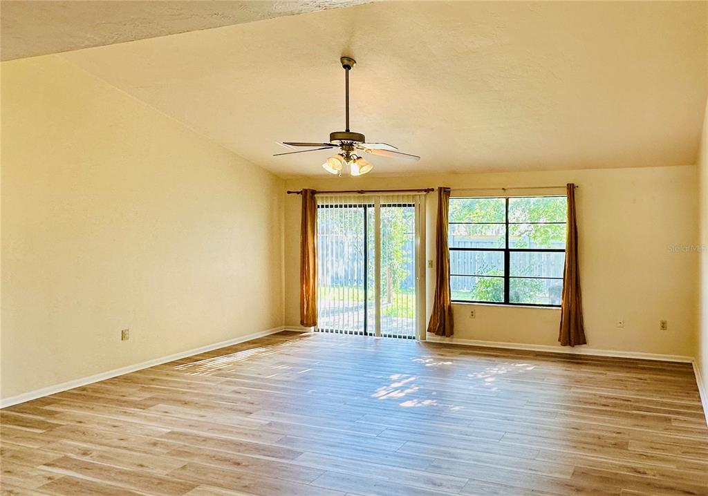 4345 Southwest 20th Lane, Unit 4345 Gainesville, FL 32607 - Photo 26 of 36 wooden floor in an empty room with a window