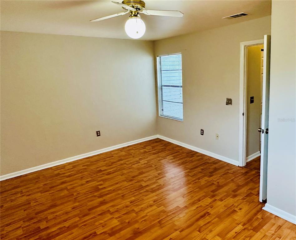 4345 Southwest 20th Lane, Unit 4345 Gainesville, FL 32607 - Photo 29 of 36 a view of empty room with wooden floor and fan