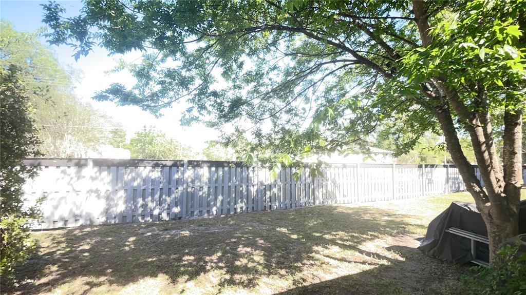 4345 Southwest 20th Lane, Unit 4345 Gainesville, FL 32607 - Photo 36 of 36 a backyard of a house with a yard and outdoor seating