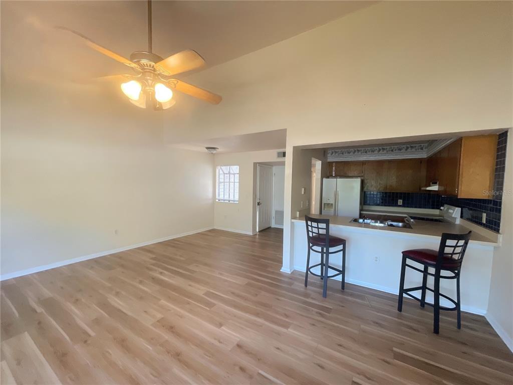 4345 Southwest 20th Lane, Unit 4345 Gainesville, FL 32607 - Photo 5 of 36 a view of a livingroom with furniture window and wooden floor