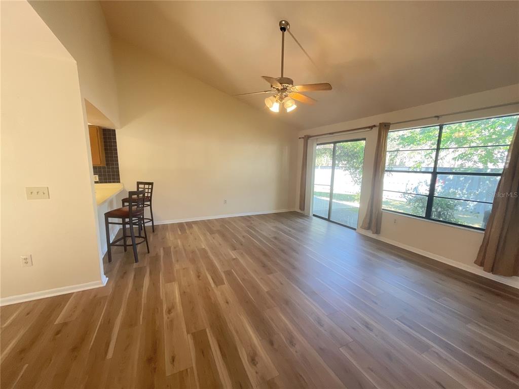 4345 Southwest 20th Lane, Unit 4345 Gainesville, FL 32607 - Photo 6 of 36 a view of empty room with wooden floor and fan