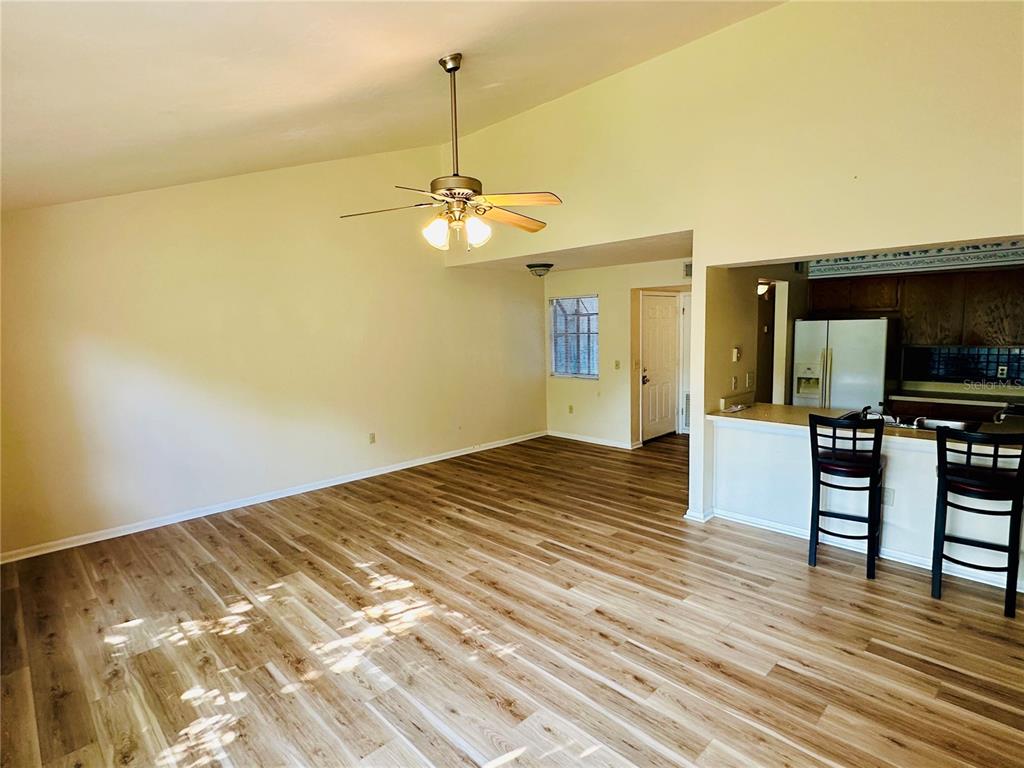 4345 Southwest 20th Lane, Unit 4345 Gainesville, FL 32607 - Photo 7 of 36 a view of a livingroom with furniture nad wooden floor