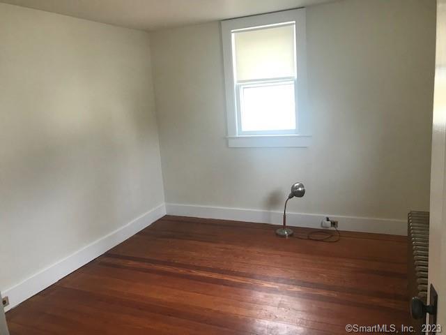 19 Greenfield Avenue Ridgefield, CT 06877 - Photo 11 of 28 an empty room with wooden floor and windows