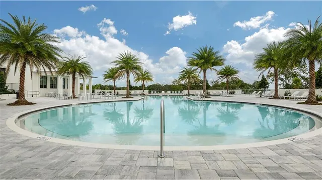 a view of a swimming pool with a table and chairs
