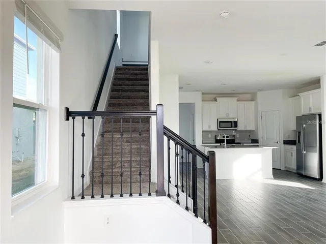 a view of kitchen with sink microwave and refrigerator