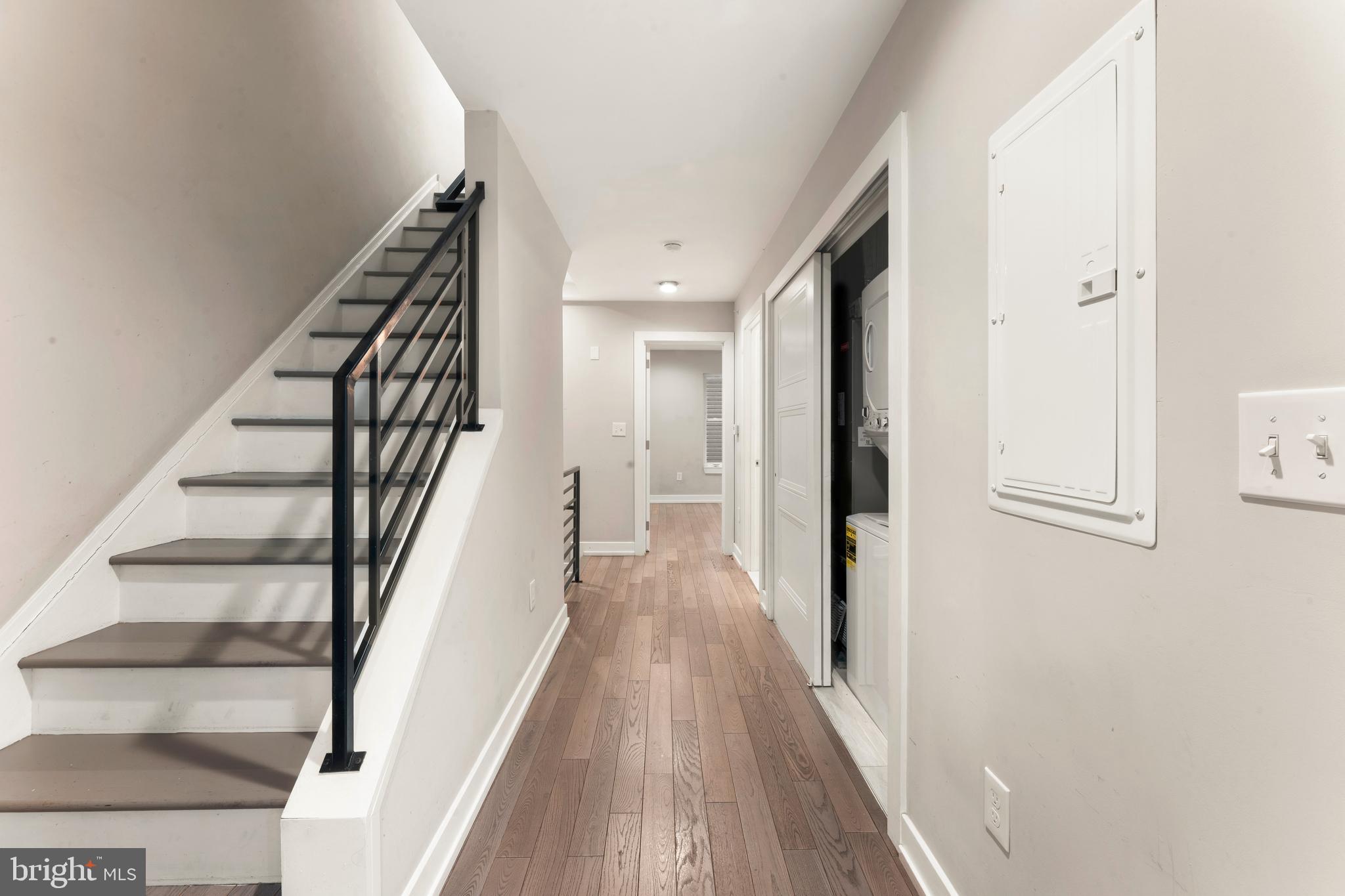 1407 North 8th Street, Unit A1 Philadelphia, PA 19122 - Photo 16 of 22 a view of a hallway with wooden floor and staircase