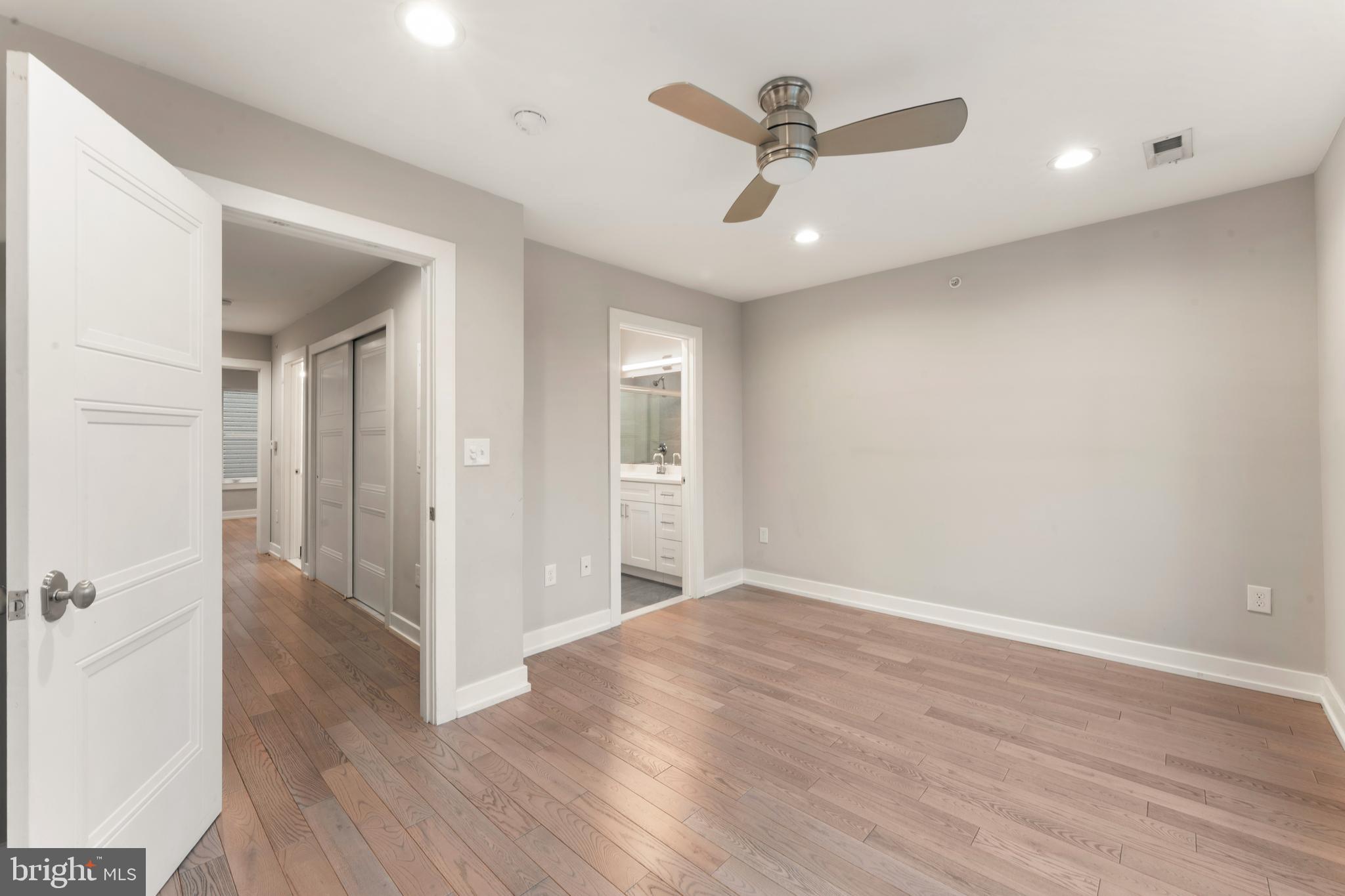 1407 North 8th Street, Unit A1 Philadelphia, PA 19122 - Photo 17 of 22 an empty room with wooden floor and a ceiling fan
