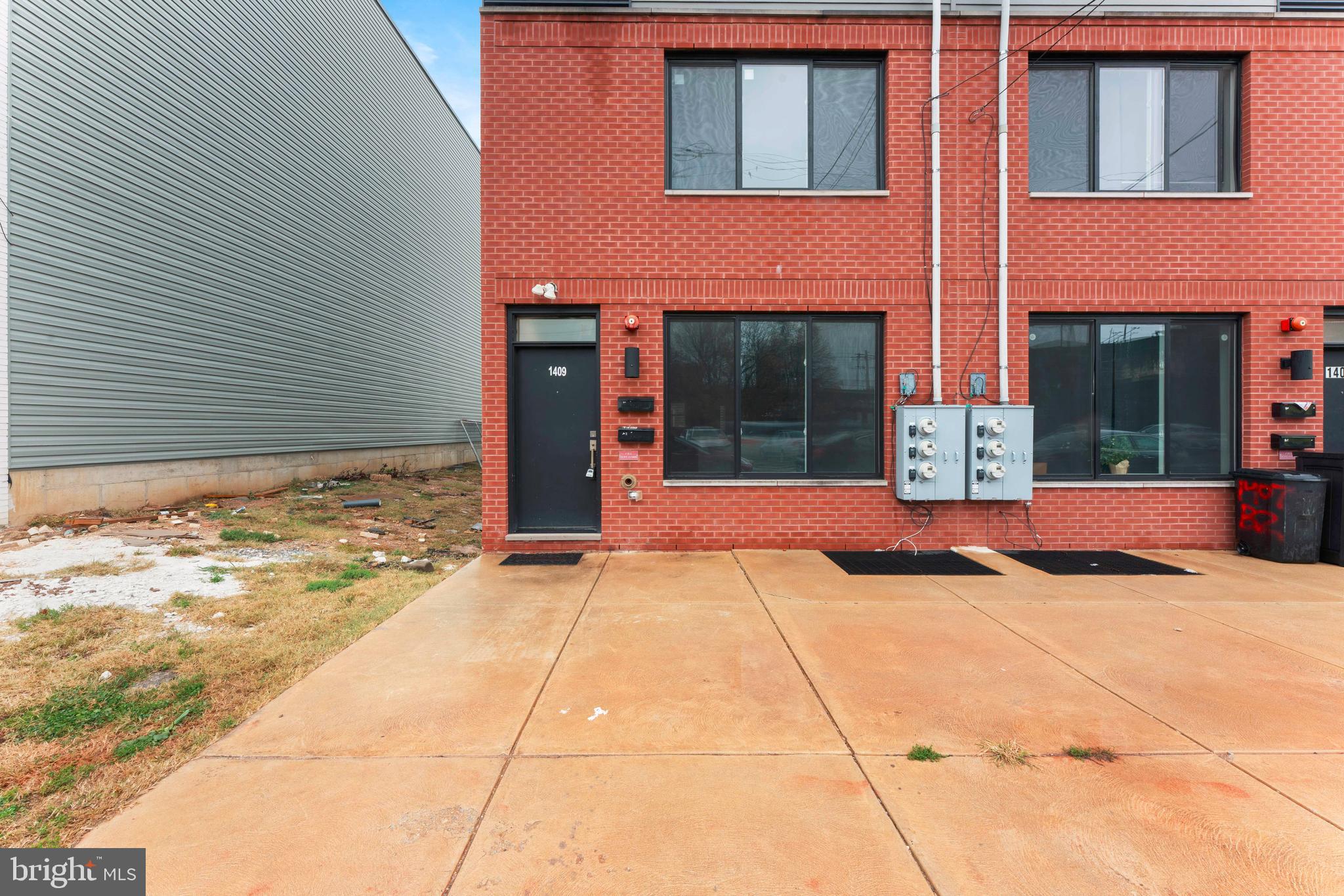 1407 North 8th Street, Unit A1 Philadelphia, PA 19122 - Photo 2 of 22 a view of a house with large windows