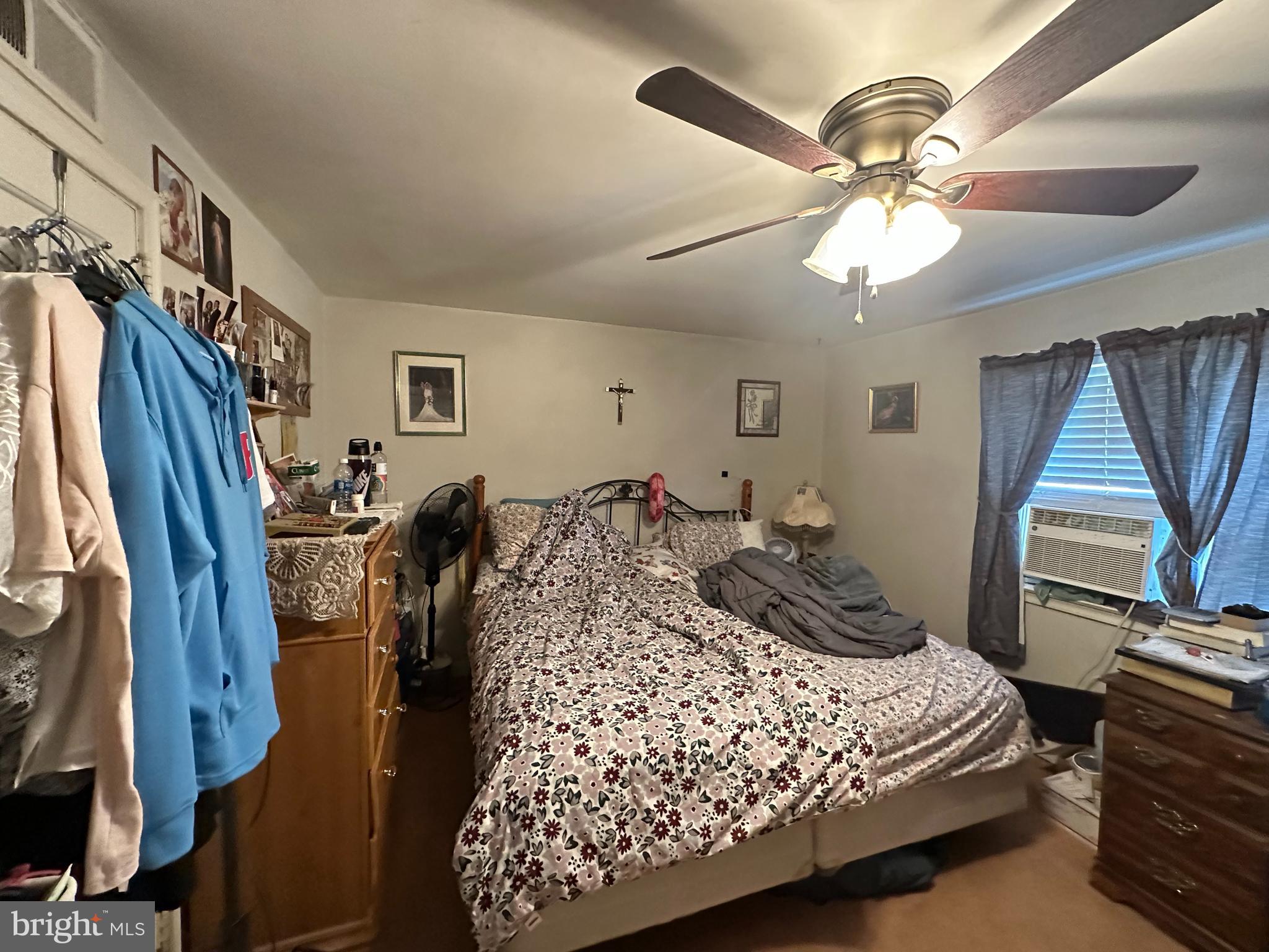 3024 Windish Street Philadelphia, PA 19152 - Photo 18 of 32 a bedroom with a bed and a chandelier