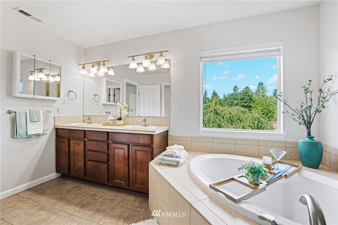 3007 182nd Place Southeast Bothell, WA 98012 - Photo 18 of 33 a spacious bathroom with a tub sink and mirror