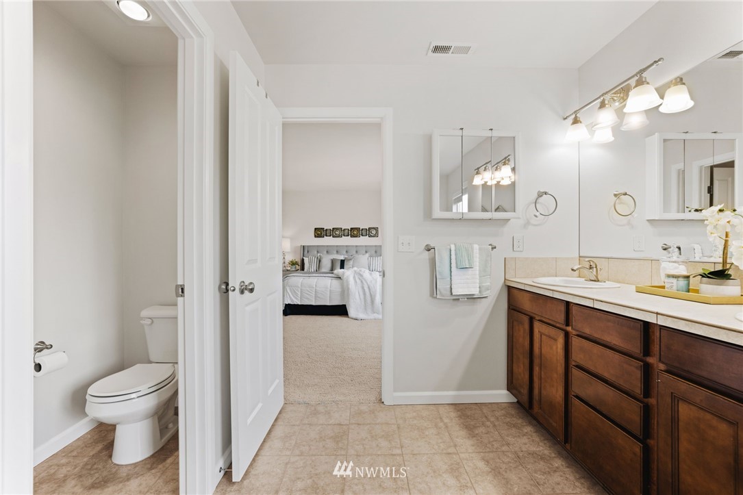 3007 182nd Place Southeast Bothell, WA 98012 - Photo 19 of 33 a spacious bathroom with a bathtub sink mirror and toilet