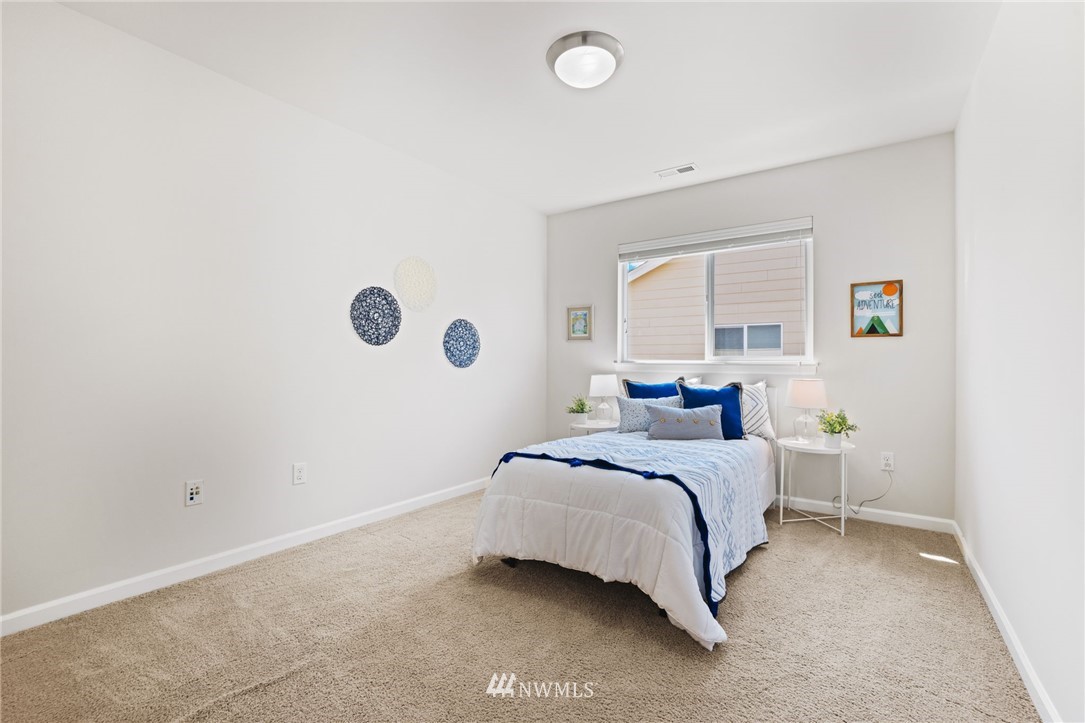 3007 182nd Place Southeast Bothell, WA 98012 - Photo 21 of 33 a bedroom with a bed and a large window
