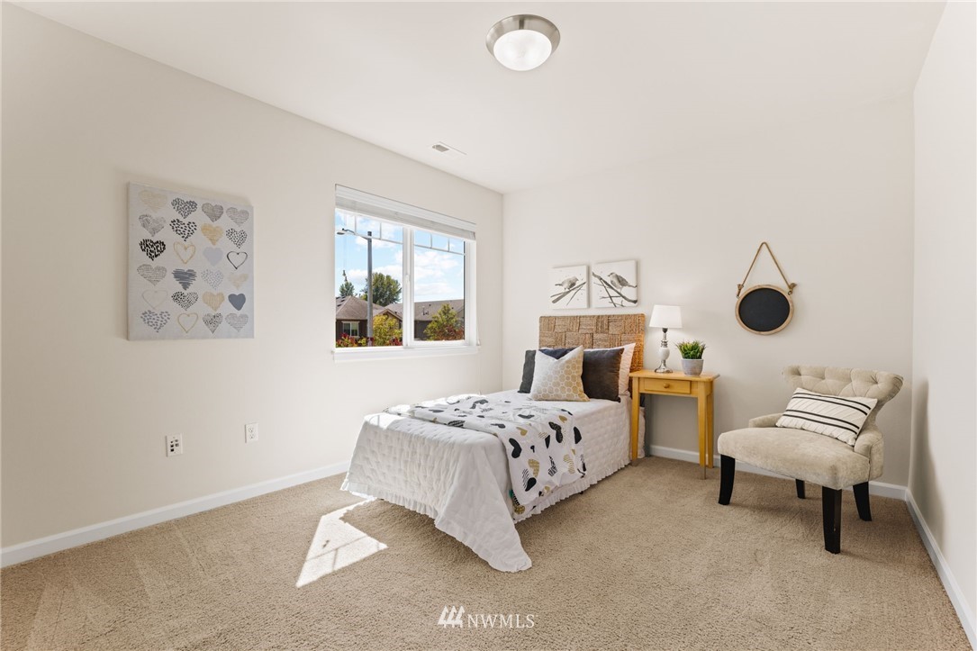 3007 182nd Place Southeast Bothell, WA 98012 - Photo 22 of 33 a bedroom with a bed and a chandelier