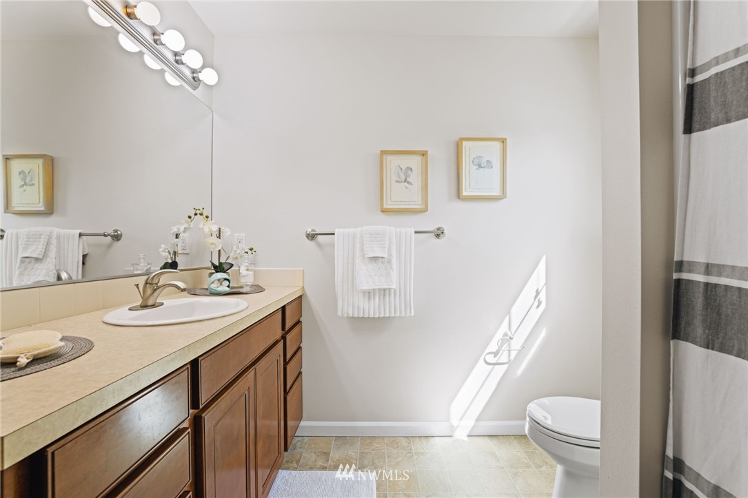 3007 182nd Place Southeast Bothell, WA 98012 - Photo 23 of 33 a bathroom with a sink a toilet and a mirror
