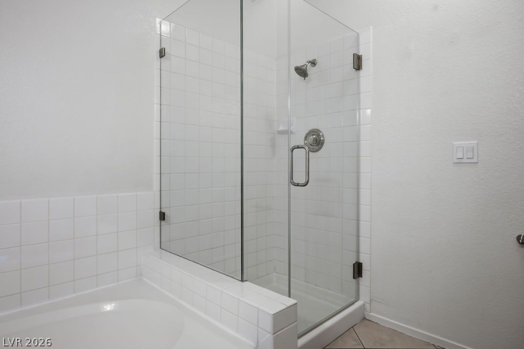 2201 Ramsgate Drive, Unit 514 Henderson, NV 89074 - Photo 21 of 28 A well-appointed shower and bath area features pristine white tile and a sleek glass enclosure.