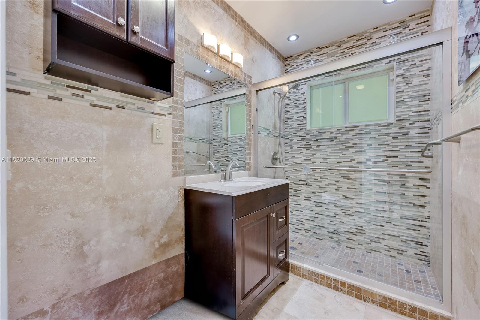 2085 Ixora Road North Miami, FL 33181 - Photo 12 of 28 a bathroom with a sink and a mirror