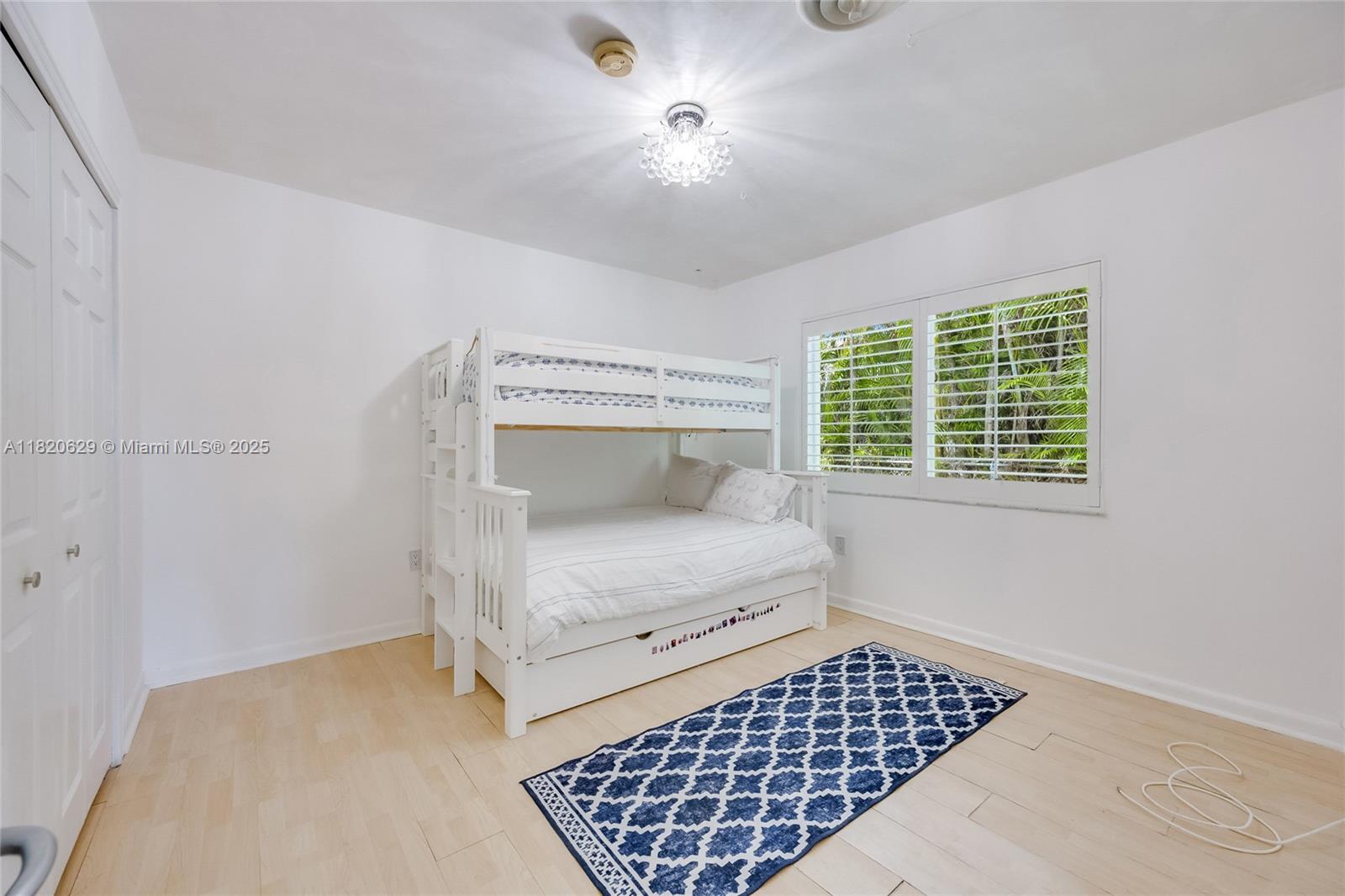 2085 Ixora Road North Miami, FL 33181 - Photo 13 of 28 a bedroom with a bed and window