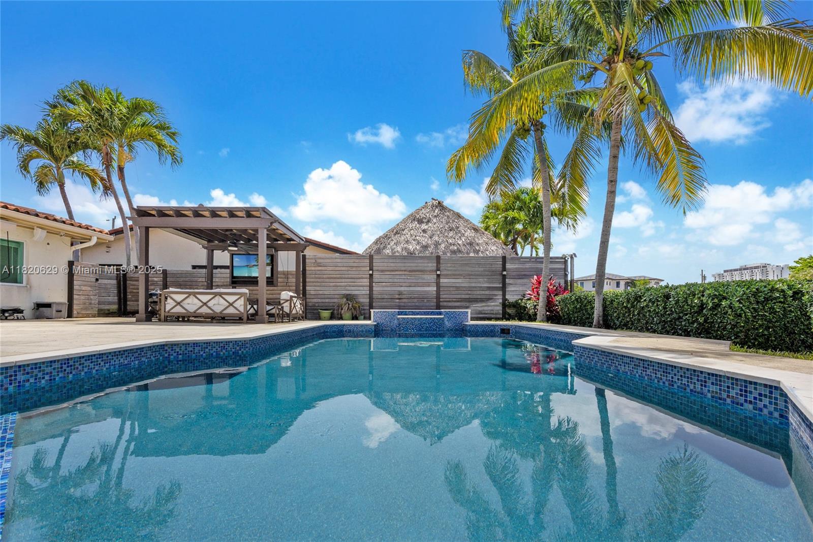 2085 Ixora Road North Miami, FL 33181 - Photo 18 of 28 a swimming pool with outdoor seating and yard