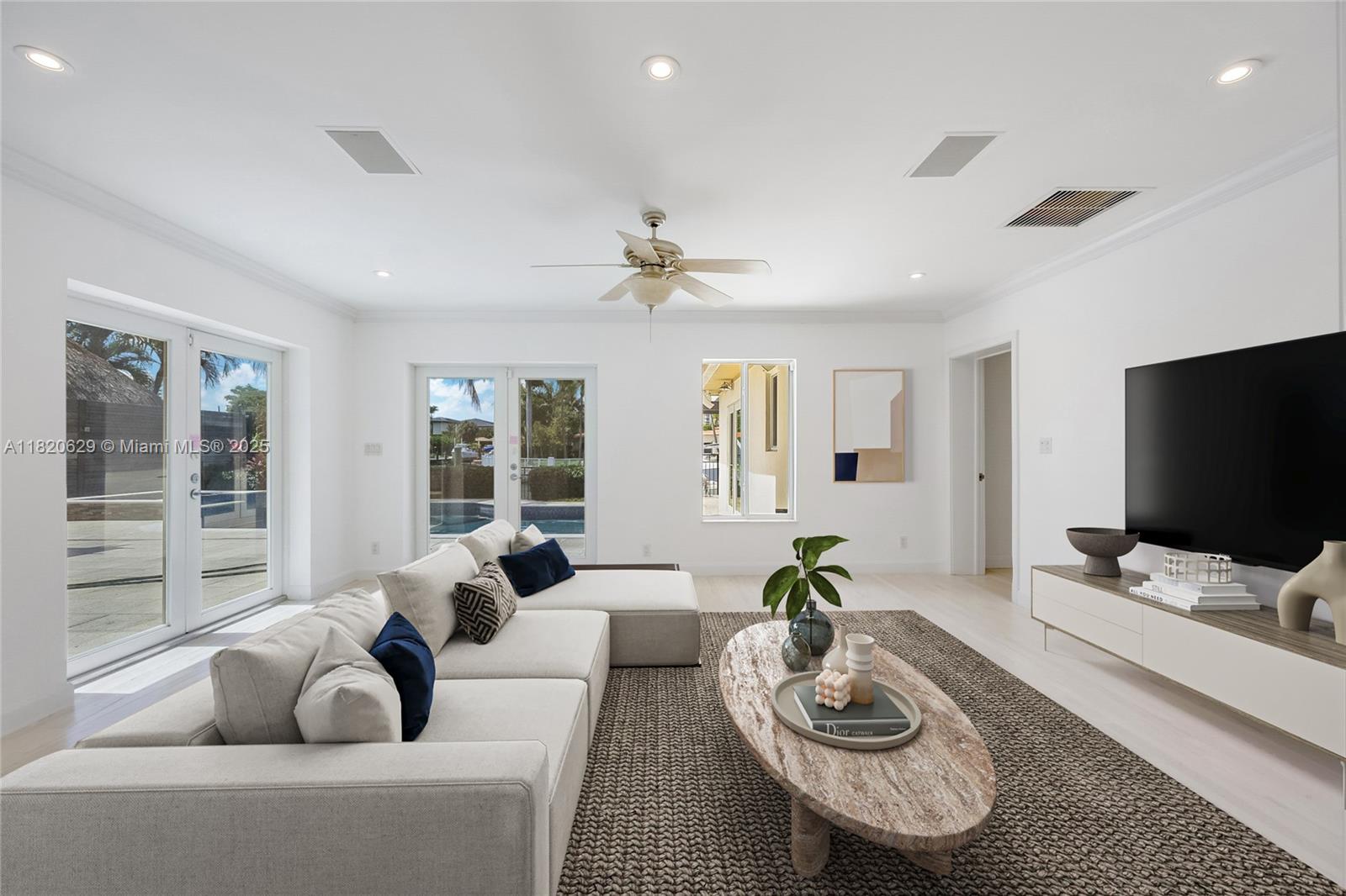 2085 Ixora Road North Miami, FL 33181 - Photo 4 of 28 a living room with furniture and a flat screen tv