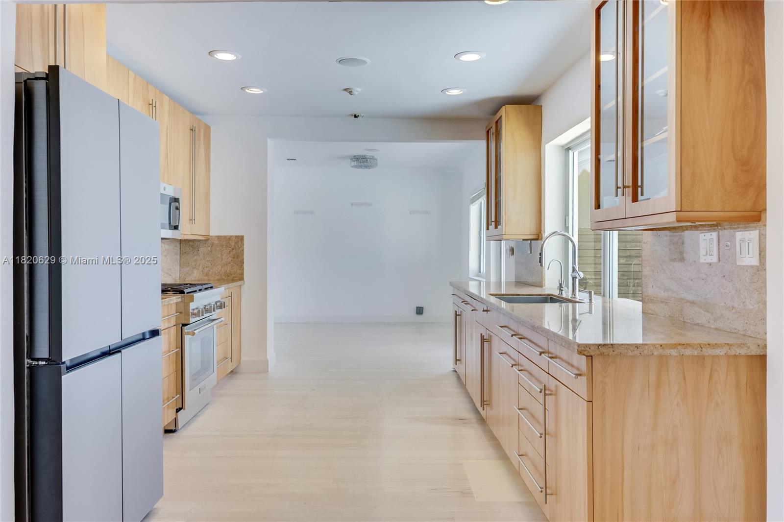 2085 Ixora Road North Miami, FL 33181 - Photo 5 of 28 a kitchen with stainless steel appliances granite countertop a refrigerator and a sink