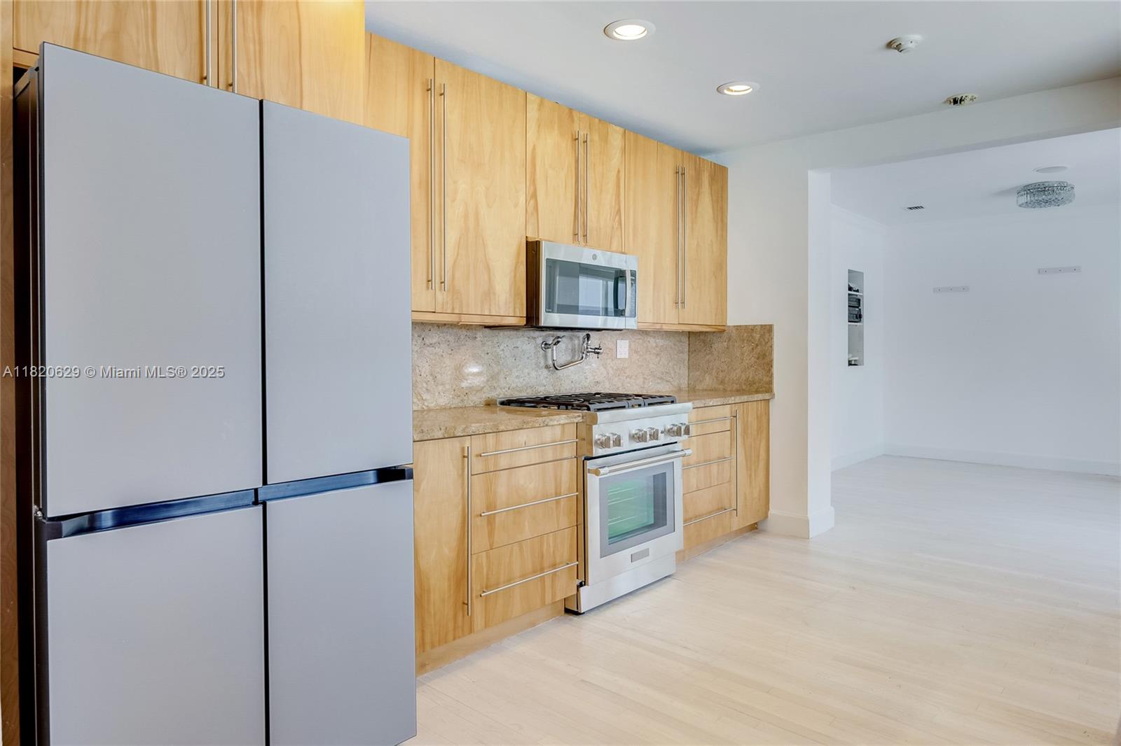2085 Ixora Road North Miami, FL 33181 - Photo 6 of 28 a kitchen with a refrigerator sink and microwave