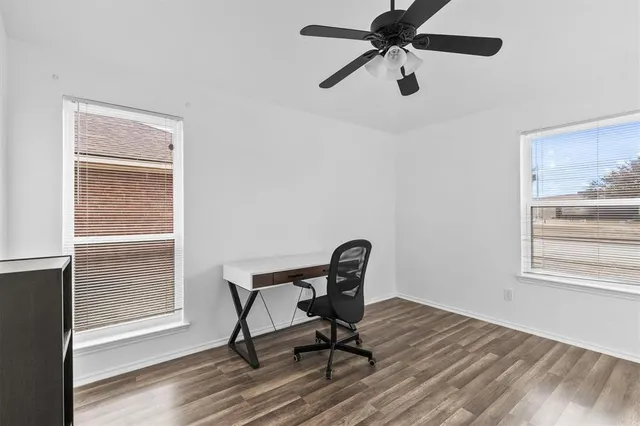 a view of a workspace with furniture and a window