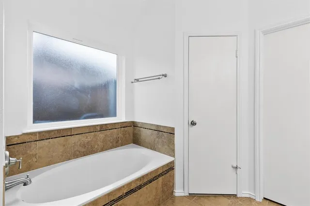 a bathroom with a tub and vanity