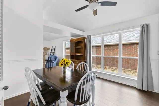 a dining room with furniture a chandelier and wooden floor