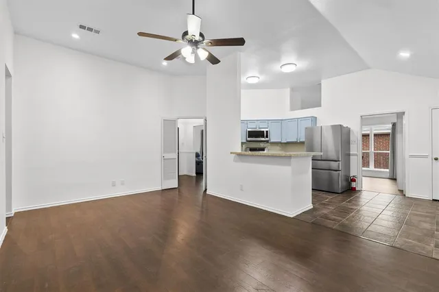a view of kitchen with stainless steel appliances refrigerator oven and cabinets