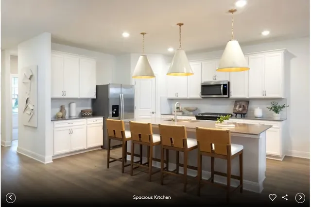 a kitchen with kitchen island granite countertop a sink a center island and cabinets