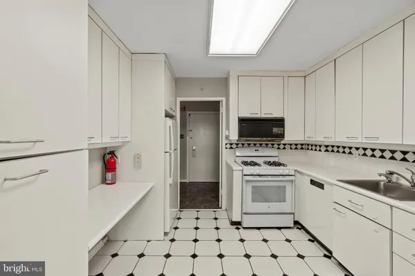 a kitchen with a sink cabinets and stainless steel appliances