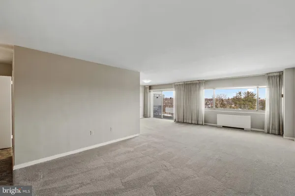 a view of a livingroom with an empty space and a window