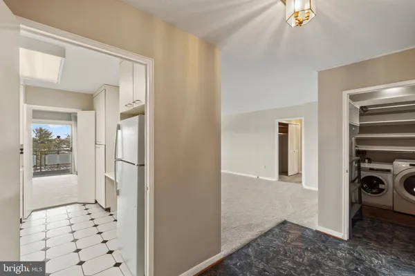 a view of a hallway view with wooden floor and a bathroom