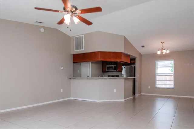 a kitchen with kitchen island a stove a sink and a refrigerator