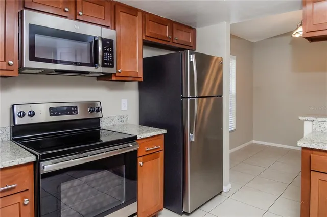 a kitchen with stainless steel appliances granite countertop a refrigerator stove and microwave