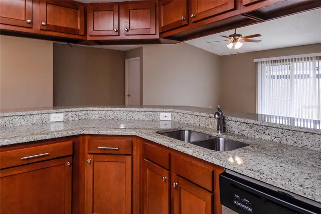 a kitchen with stainless steel appliances granite countertop a sink and cabinets