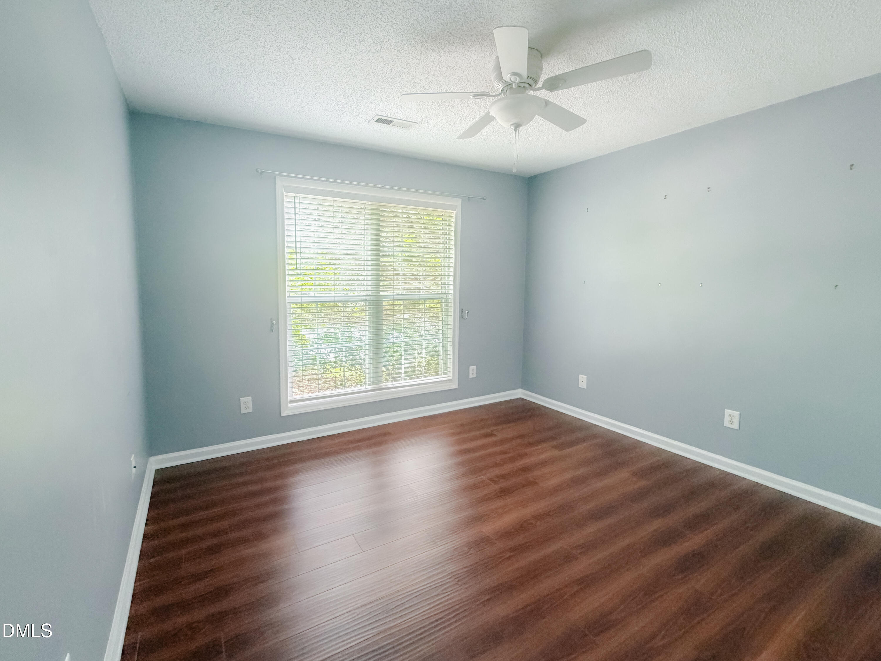 6304 Forest Ridge Drive Durham, NC 27713 - Photo 11 of 29 an empty room with wooden floor and windows