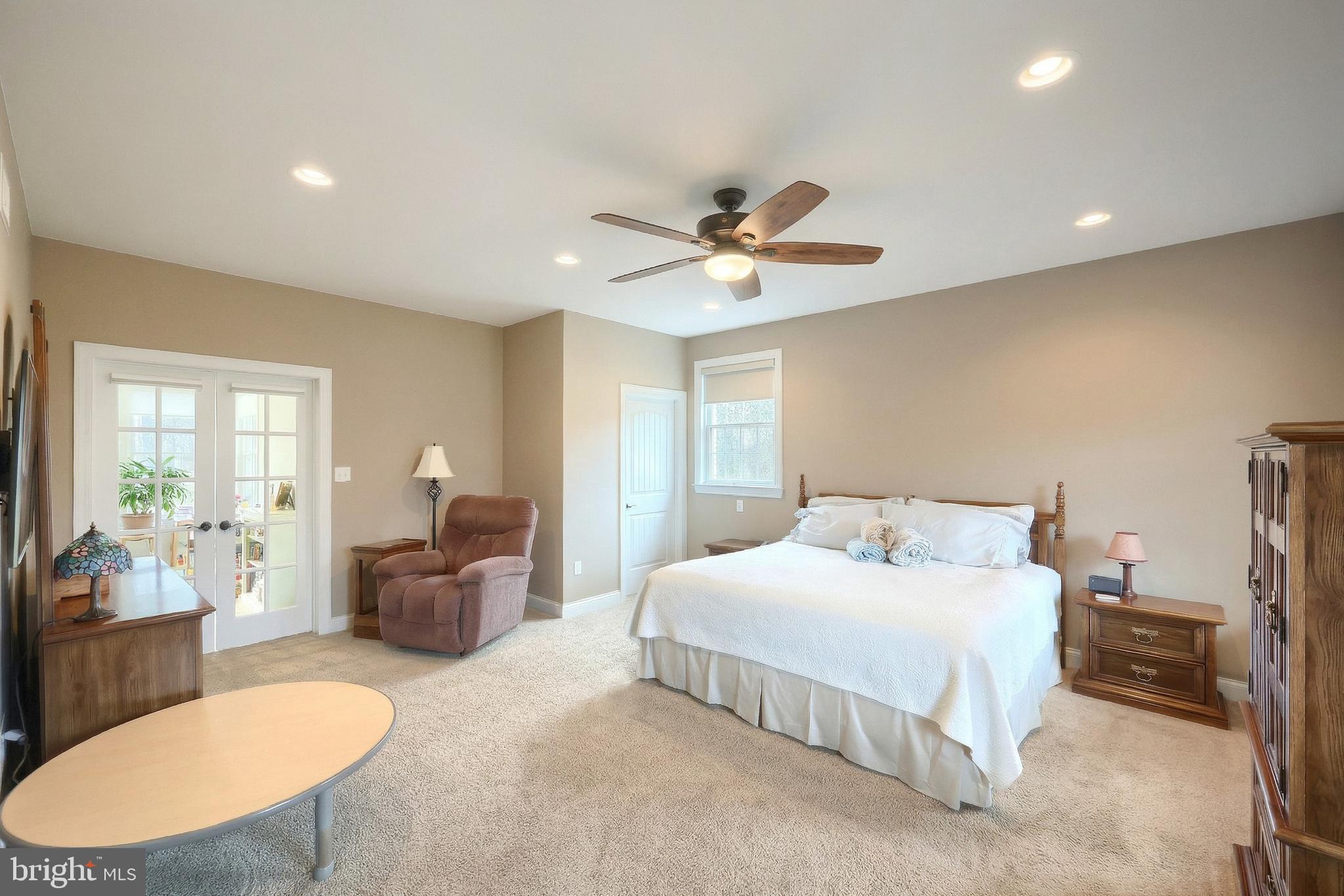 108 Pickett Road Dover, PA 17315 - Photo 28 of 64 a bedroom with a large bed couch chandelier and a window