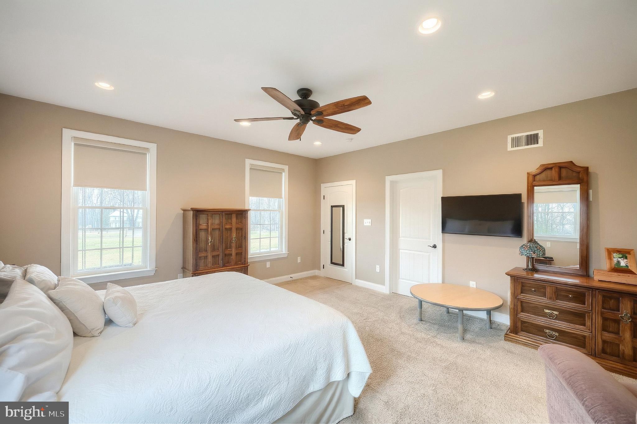108 Pickett Road Dover, PA 17315 - Photo 29 of 64 a spacious bedroom with a large bed a flat screen tv and a dresser