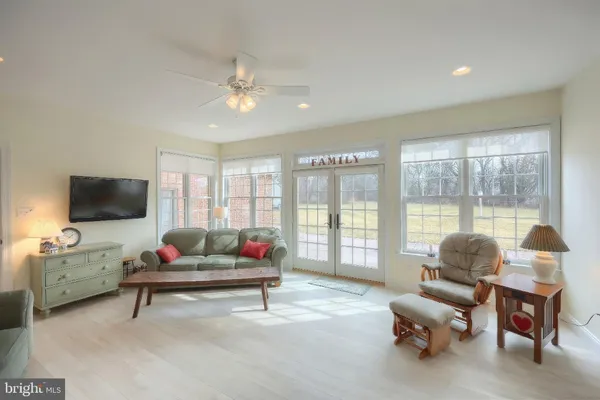 a kitchen with stainless steel appliances granite countertop a stove a sink a stove a kitchen island with chairs and wooden floor