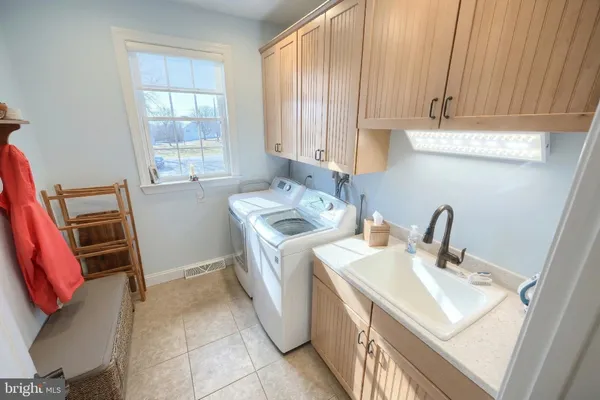 a large white kitchen with a large window