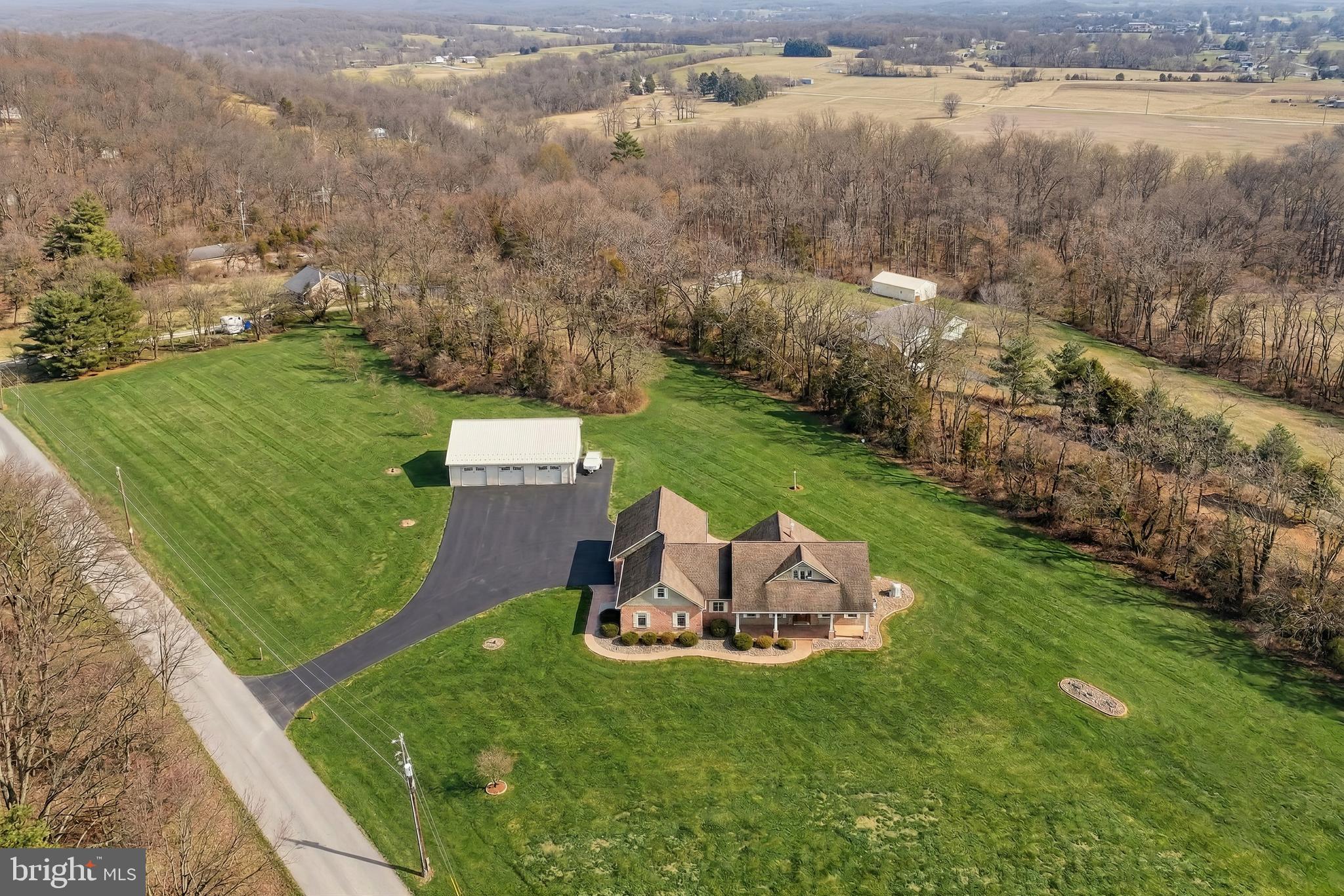 108 Pickett Road Dover, PA 17315 - Photo 5 of 64 a front view of a house with a garden and lake view