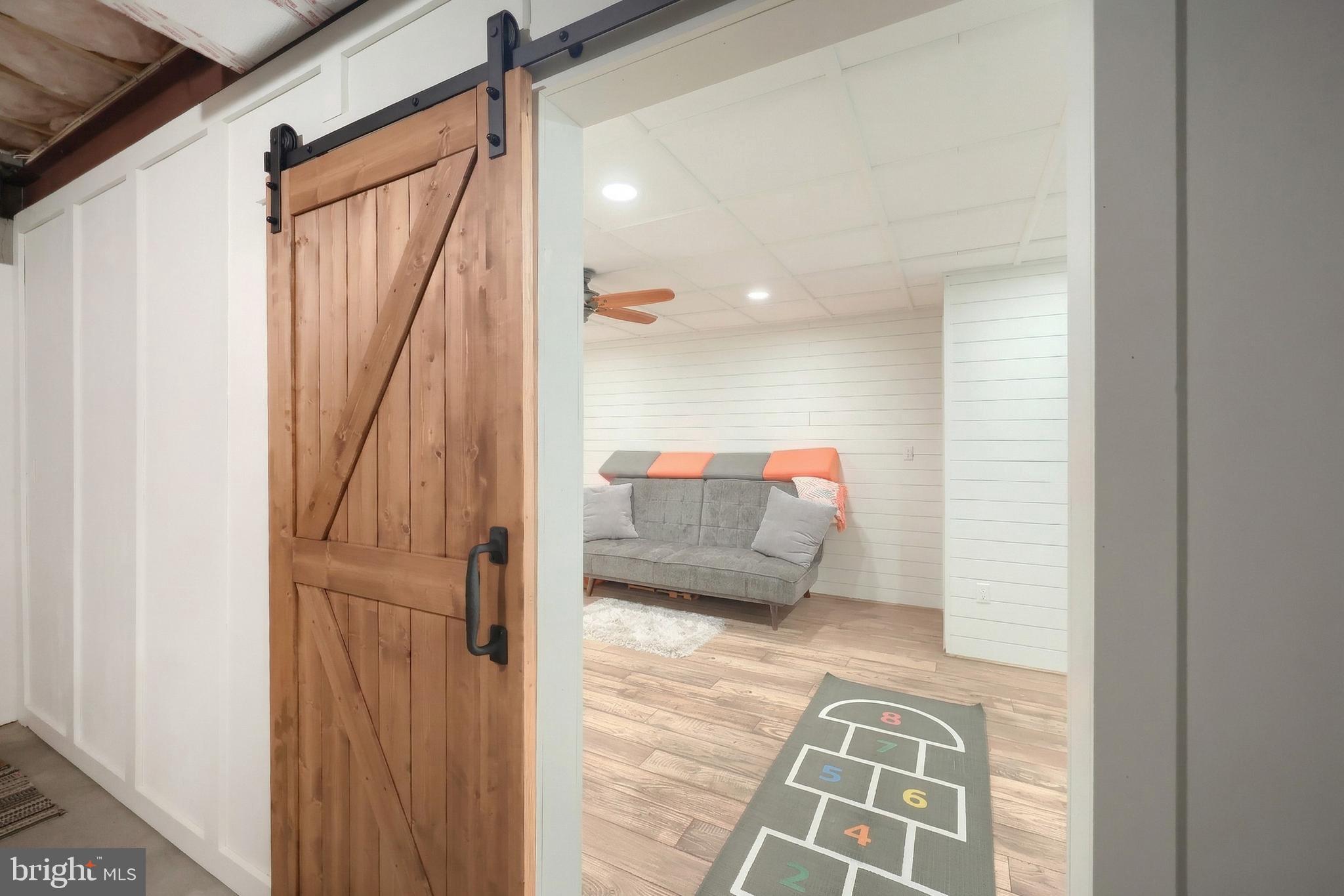 108 Pickett Road Dover, PA 17315 - Photo 55 of 64 a hallway with a couch and wooden floor