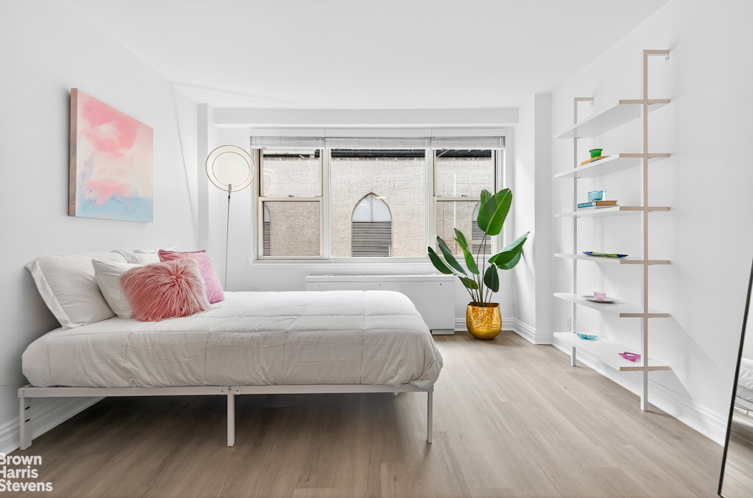 520 East 72nd Street, Unit 4J Manhattan, NY 10021 - Photo 2 of 15 a bedroom with a bed and wooden floor